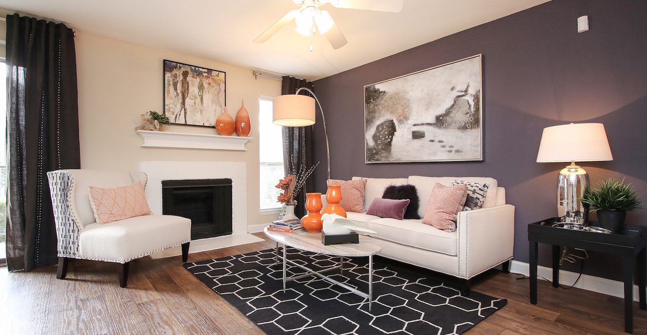 a living room with hardwood floors and a fireplace at The Westmount at London Park