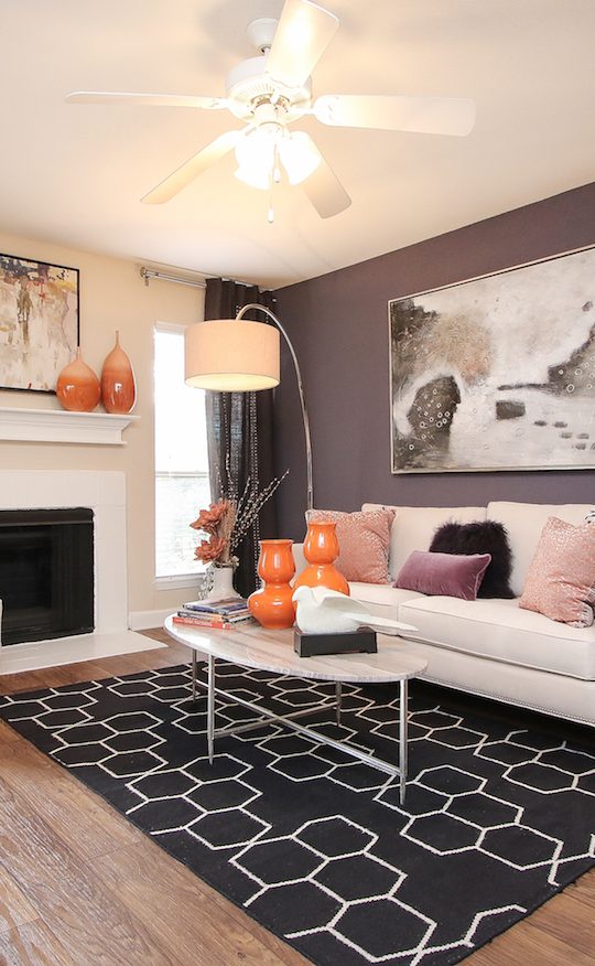 a living room with hardwood floors and a fireplace at The Westmount at London Park