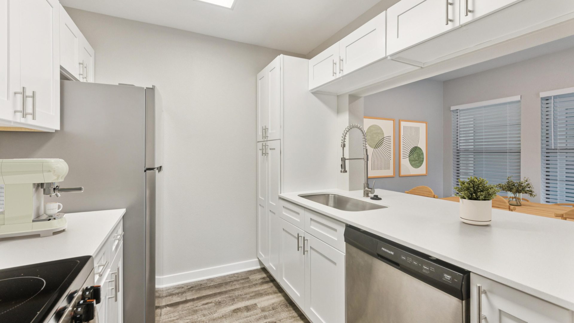 kitchen with stainless steel appliances and white cabinets at The Westmount at London Park