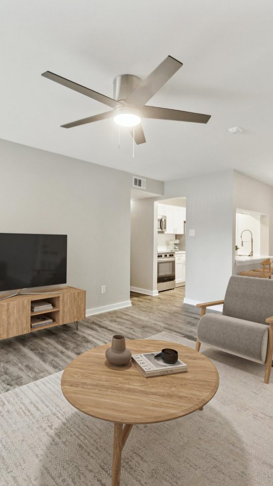 a living room with a ceiling fan and a couch at The Westmount at London Park